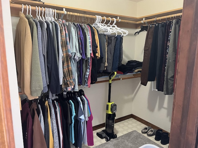 walk in closet with tile patterned floors