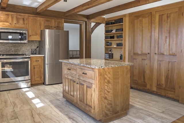 kitchen with light stone countertops, arched walkways, stainless steel appliances, tasteful backsplash, and beamed ceiling