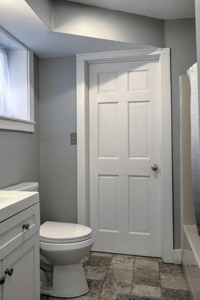 bathroom featuring vanity, a shower with curtain, and toilet