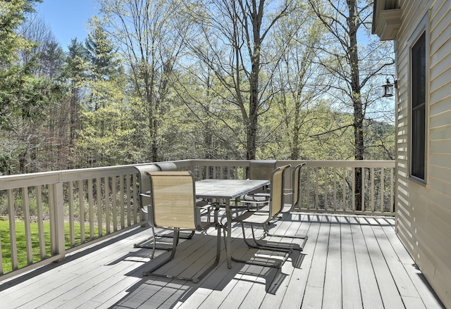 wooden deck featuring outdoor dining area