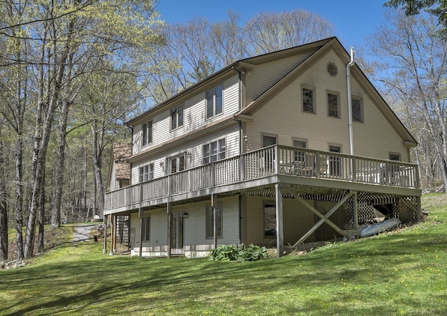 rear view of house with a lawn and a deck