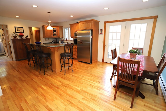 dining space featuring light wood-type flooring and recessed lighting