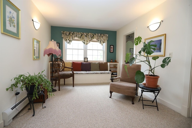 living area with carpet flooring, a baseboard radiator, and baseboards