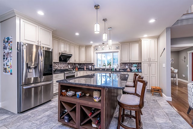 kitchen with appliances with stainless steel finishes, decorative backsplash, open shelves, and a kitchen bar