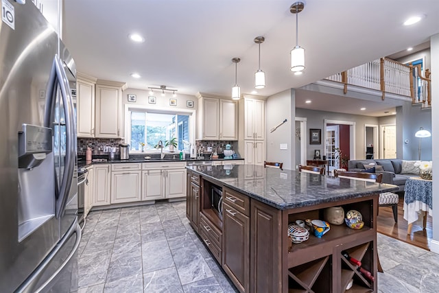kitchen featuring stainless steel appliances, open shelves, decorative backsplash, and dark stone countertops