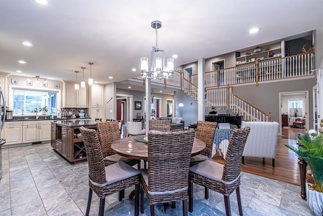 dining area featuring an inviting chandelier, recessed lighting, and stairs