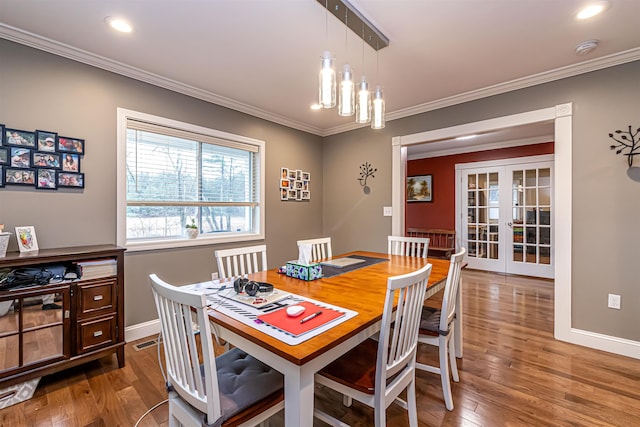 dining space featuring french doors, crown molding, wood finished floors, baseboards, and recessed lighting