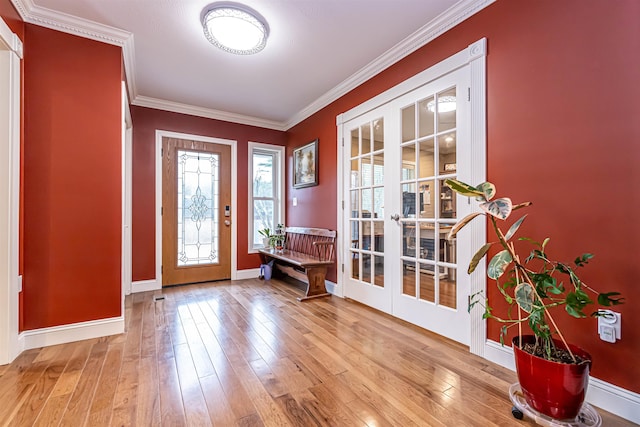 entrance foyer featuring crown molding, baseboards, french doors, and hardwood / wood-style flooring