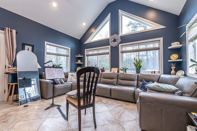 living room with high vaulted ceiling, plenty of natural light, and recessed lighting