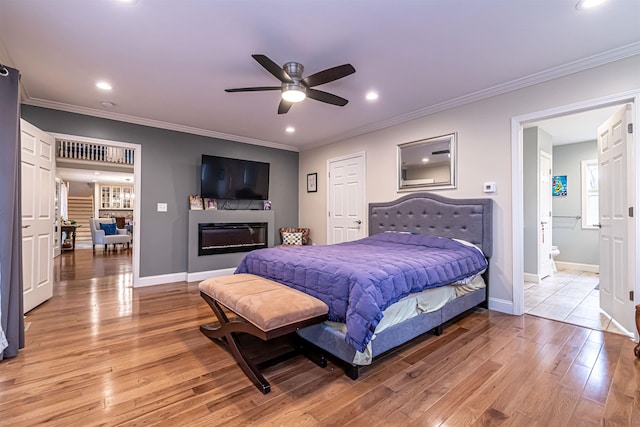 bedroom with baseboards, ornamental molding, and light wood-style floors