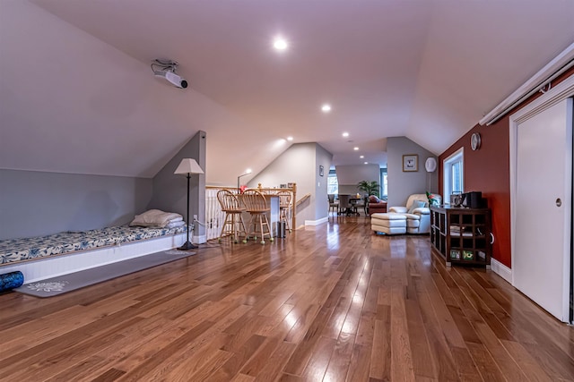 bonus room with baseboards, wood finished floors, and lofted ceiling