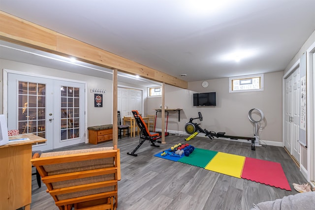 exercise area featuring baseboards, french doors, and wood finished floors