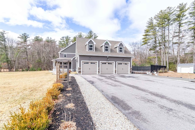 view of property exterior featuring fence, an attached garage, and driveway