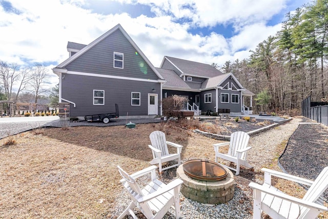 rear view of house featuring an outdoor fire pit and a patio area