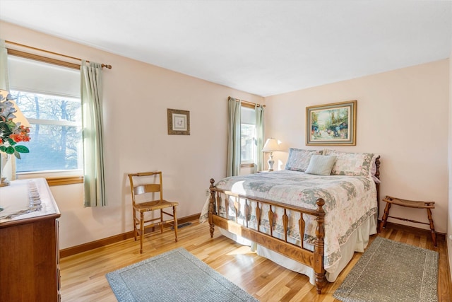 bedroom with baseboards and light wood-type flooring