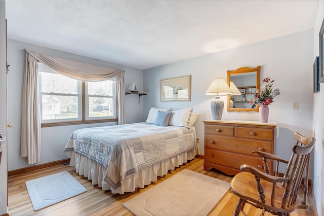 bedroom featuring light wood-type flooring and baseboards