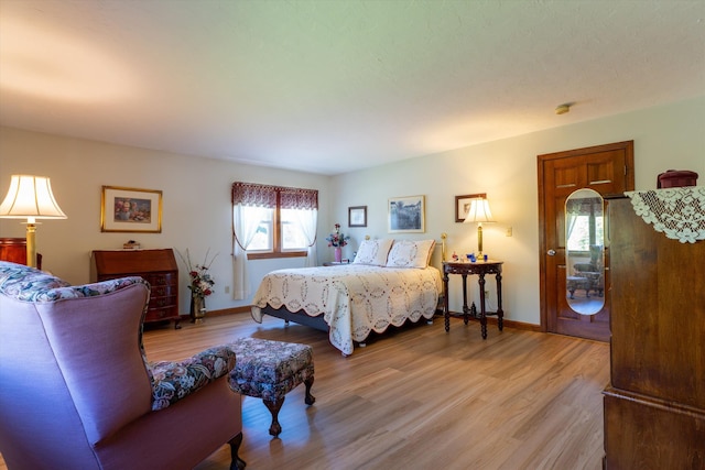 bedroom featuring baseboards and light wood-style flooring
