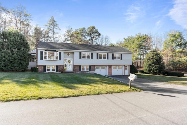 bi-level home with a front lawn, aphalt driveway, french doors, a chimney, and an attached garage