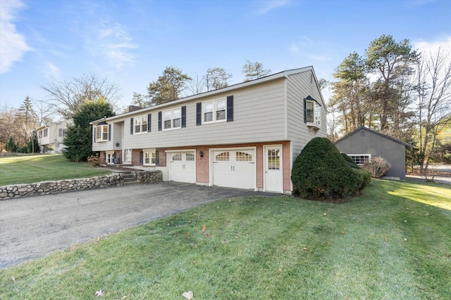 view of front of home with a chimney, a garage, brick siding, aphalt driveway, and a front lawn