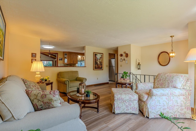 living area with baseboards and light wood-style flooring