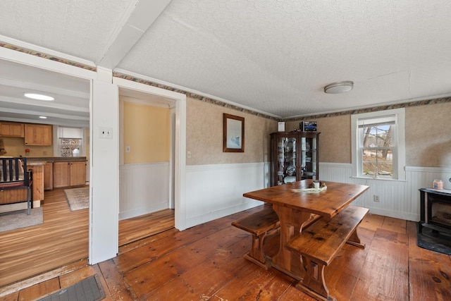 dining room featuring light wood-type flooring and wainscoting