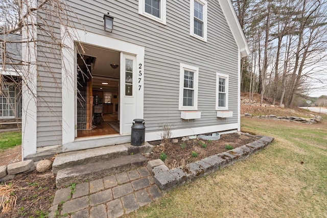 property entrance with a yard