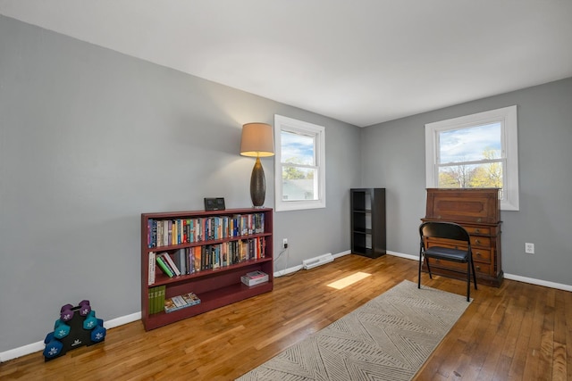 living area featuring baseboards and wood finished floors