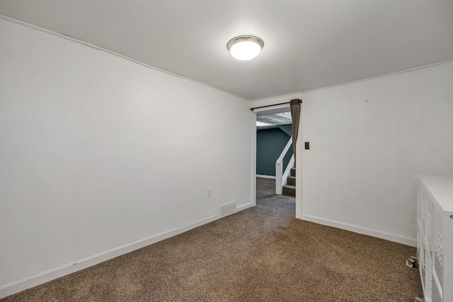 unfurnished room featuring baseboards, carpet, and visible vents