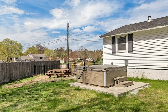 view of yard with a fenced backyard and a hot tub