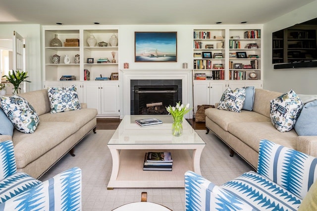 living room featuring a fireplace and built in shelves