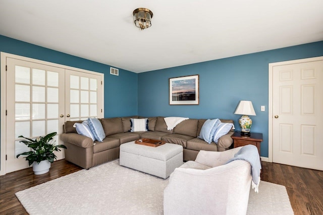living area featuring french doors, dark wood-type flooring, and visible vents