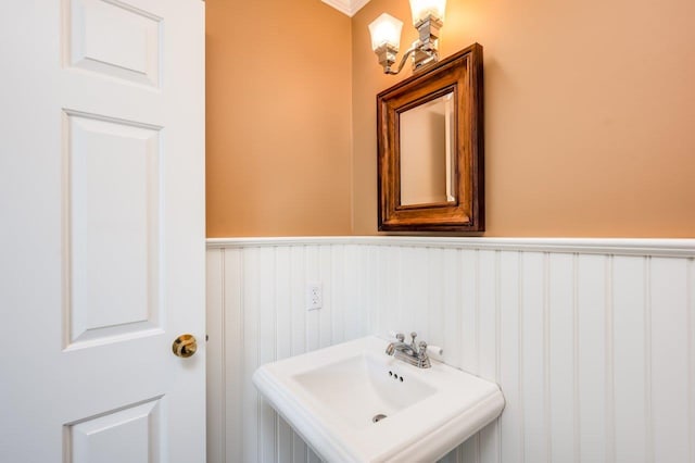 bathroom with a sink and wainscoting