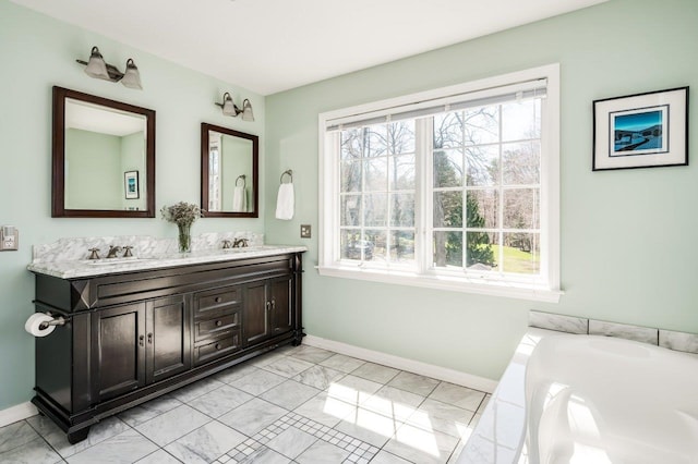 full bathroom with a sink, baseboards, double vanity, and marble finish floor