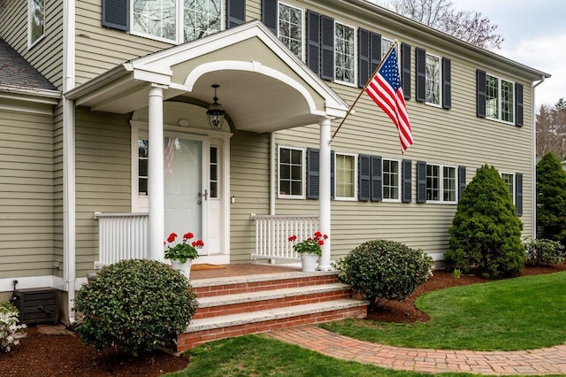 view of exterior entry featuring covered porch