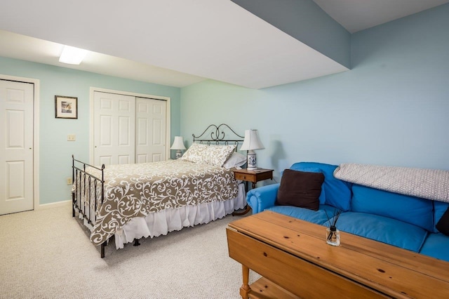 bedroom with a closet, carpet flooring, and baseboards