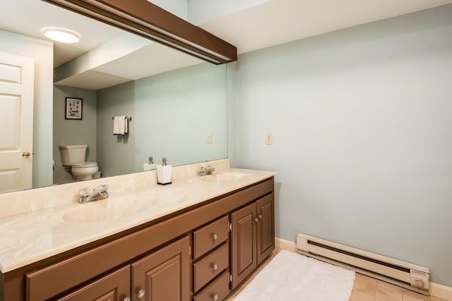 bathroom featuring double vanity, toilet, a sink, and a baseboard radiator