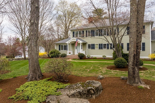 view of front of property with a chimney and a front yard