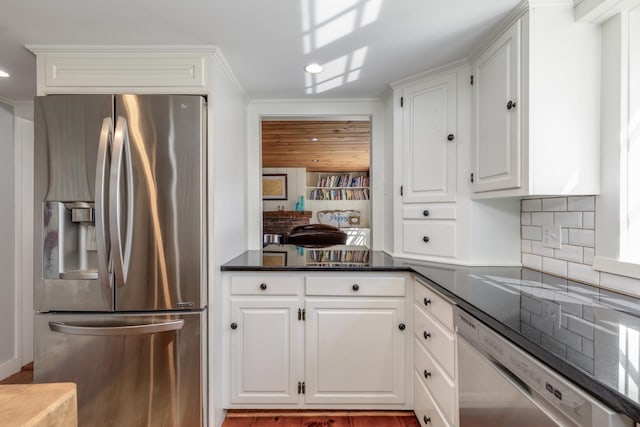 kitchen featuring ornamental molding, appliances with stainless steel finishes, backsplash, and white cabinets