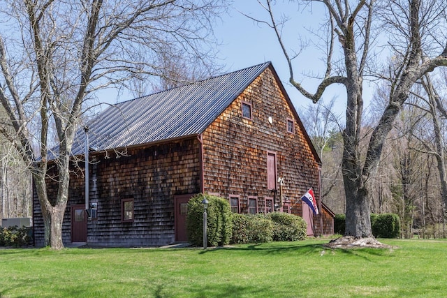 view of home's exterior featuring a yard and metal roof