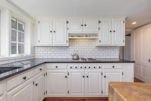 kitchen with white cabinets and dark countertops