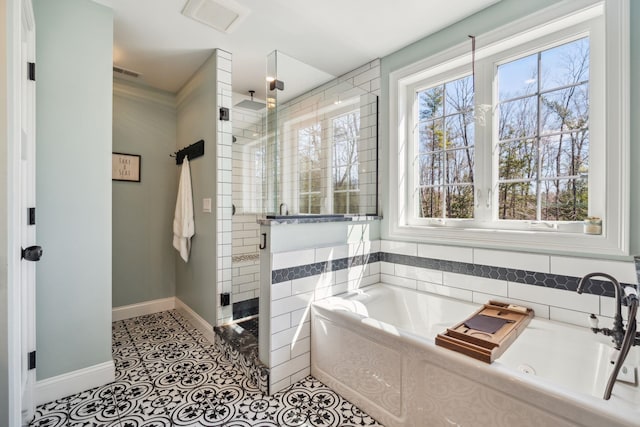 full bathroom featuring tile patterned flooring, baseboards, a shower stall, visible vents, and a garden tub