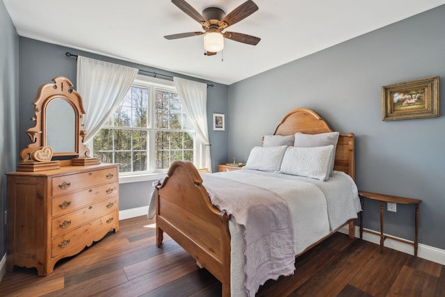 bedroom featuring baseboards, ceiling fan, and dark wood-style floors
