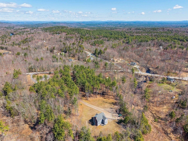 birds eye view of property featuring a wooded view