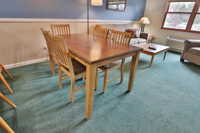 dining room featuring carpet flooring and baseboards