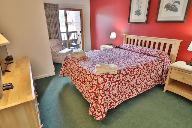 carpeted bedroom with baseboards and access to exterior