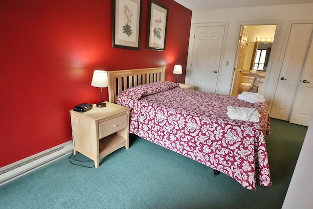 bedroom with ensuite bathroom, carpet, and baseboard heating