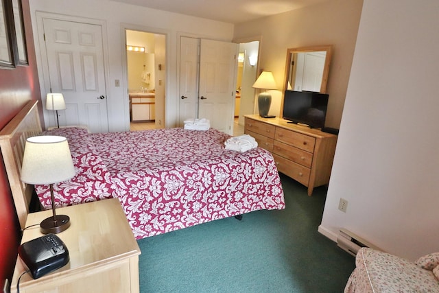 carpeted bedroom featuring ensuite bath