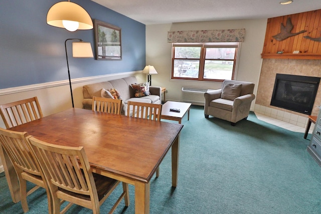 dining area with carpet flooring and a tile fireplace
