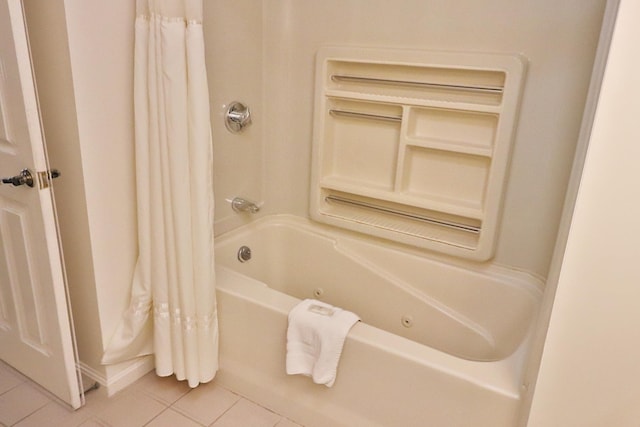 bathroom featuring shower / bath combo with shower curtain and tile patterned flooring