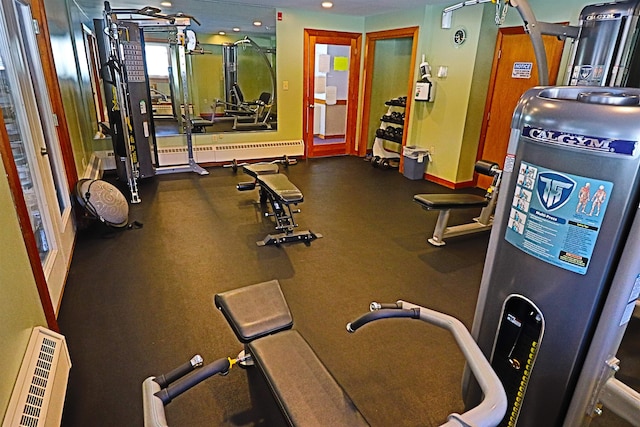 workout area with recessed lighting, baseboards, and a baseboard heating unit